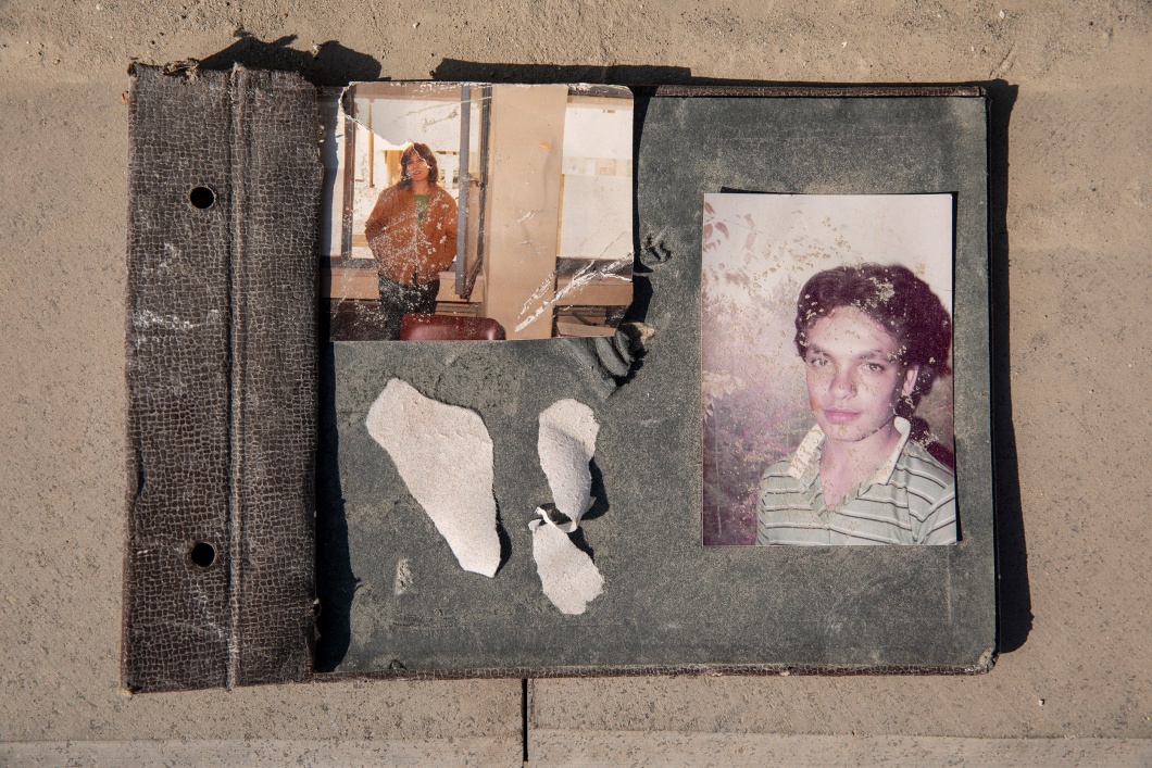 Ein staubbedecktes, beschädigtes Familienalbum in Hatay mit zwei Fotos, auf denen Menschen zu sehen sind